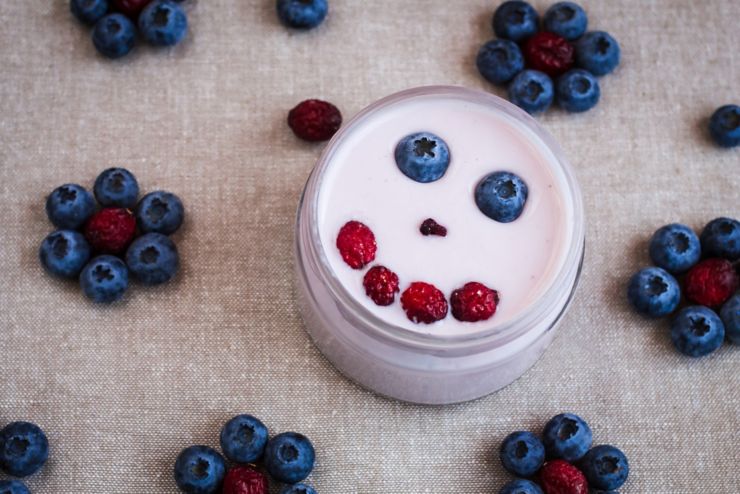 Blueberry yogurt with a smiling face. Kids breakfast of yogurt. Top view; Shutterstock ID 403723450; PO: Ellen Kocher - Back to school