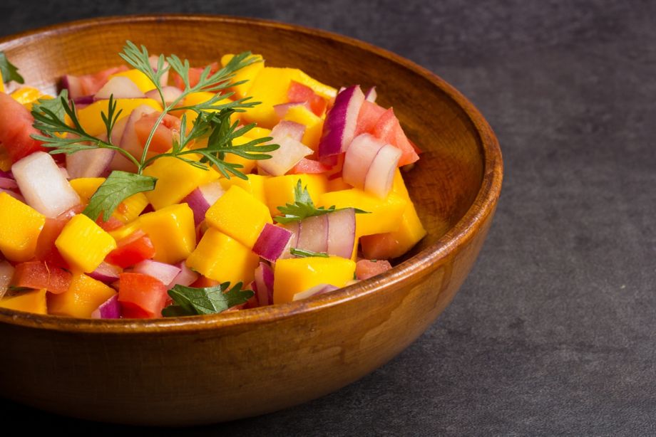 Mango Salsa on wooden bowl, side view