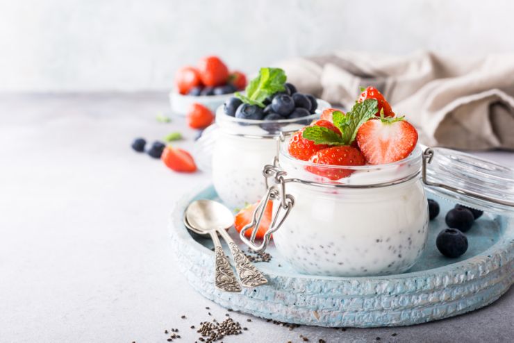 Chia seed pudding with berries in glass jar. Superfoods concept with copy space.