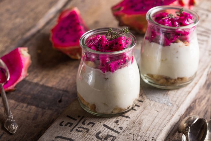 Homemade yoghurt with Ripe Dragon fruit, Pitaya or Pitahaya isolated on wooden background, fruit healthy concept