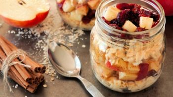 Autumn overnight oats with apples and cranberries in a mason jar