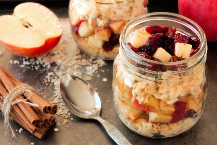 Autumn overnight oats with apples and cranberries in a mason jar