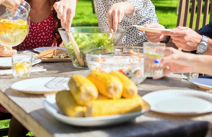 leisure, holidays, eating, people and food concept - happy friends having dinner at summer garden party; Shutterstock ID 531990733; PO: Grillen_Sommer