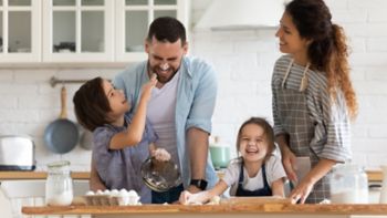 Overjoyed young family with little preschooler kids have fun cooking baking pastry or pie at home together, happy smiling parents enjoy weekend play with small children doing bakery cooking in kitchen; Shutterstock ID 1660546018