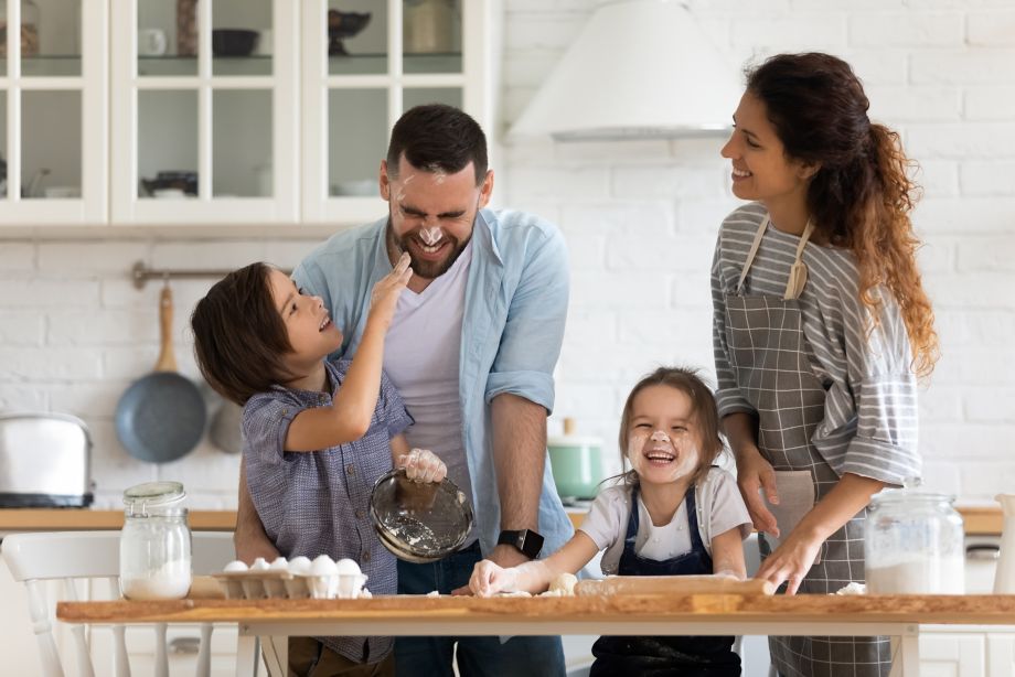 Overjoyed young family with little preschooler kids have fun cooking baking pastry or pie at home together, happy smiling parents enjoy weekend play with small children doing bakery cooking in kitchen; Shutterstock ID 1660546018