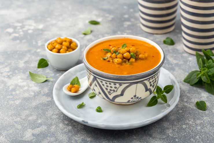 Creamy vegetable soup  garnished  with chickpeas and herbs; Shutterstock ID 770184394; purchase_order: UK BLOG; job: ; client: UK Marketing; other: 