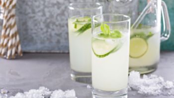 Basil lime and cucumber cooler in pitcher and tall glasses