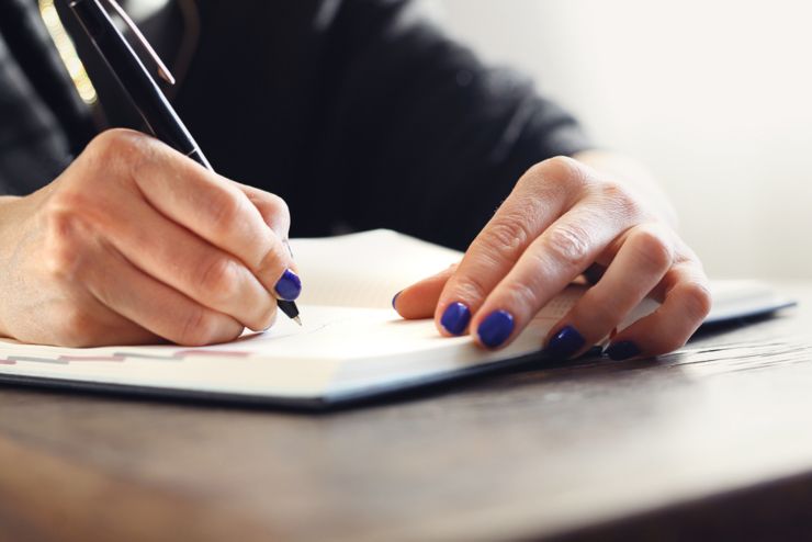 Important meeting. Woman writes a note in the calendar