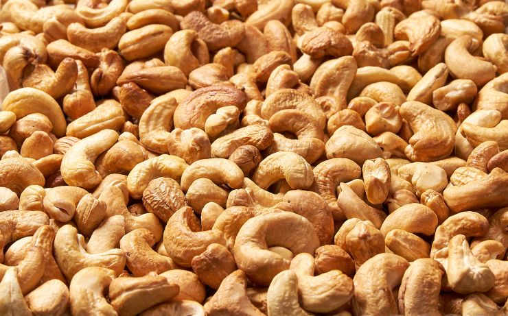 Roasted cashew nuts, texture and background . Tasty cashew nuts as background, cashew nuts texture. flat lay