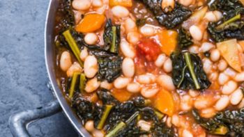 Soup with vegetables, beans, kale, top view.Typical tuscan soup, ribollita. 