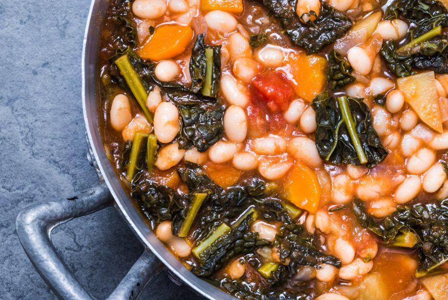 Soup with vegetables, beans, kale, top view.Typical tuscan soup, ribollita. 