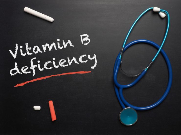 Blackboard with the words Vitamin B deficiency and a stethoscope, medical or health care concept