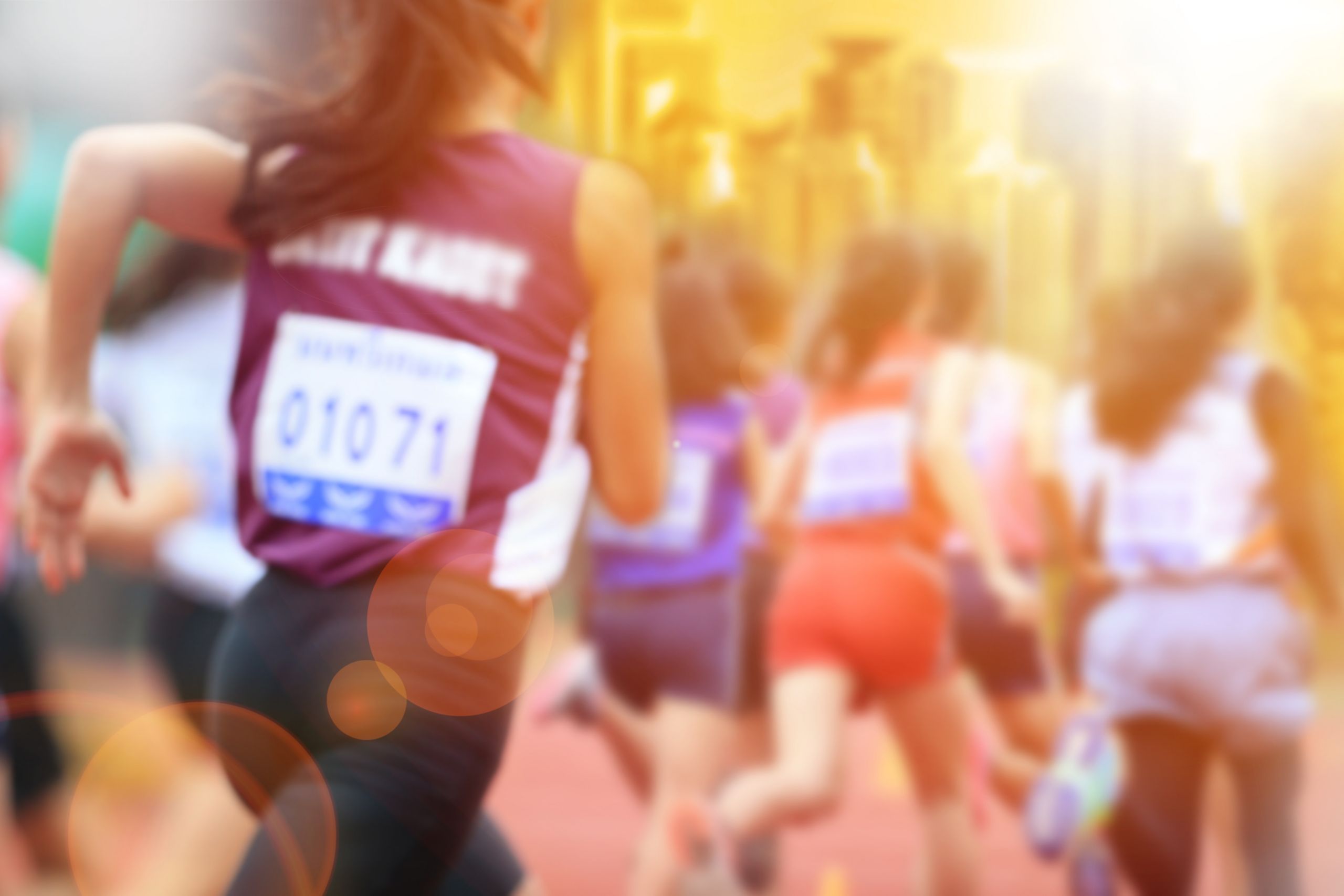 Blurred image of women marathon racing in the city with lans flare.; Shutterstock ID 556077157; Purchase Order: Informed Choice Fact Sheet; Job: ; Client/Licensee: ; Other: 